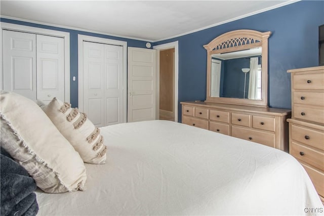 bedroom with multiple closets and ornamental molding