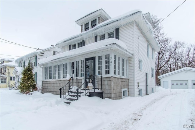 traditional style home featuring an outdoor structure and a detached garage