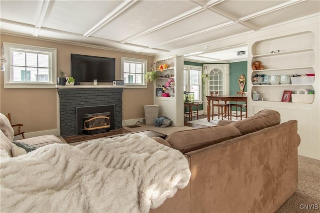 carpeted living area featuring coffered ceiling, a fireplace, and baseboards