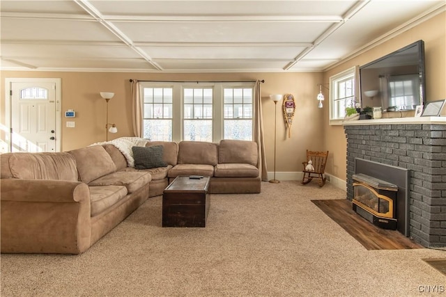 living room featuring a wood stove, carpet, and baseboards