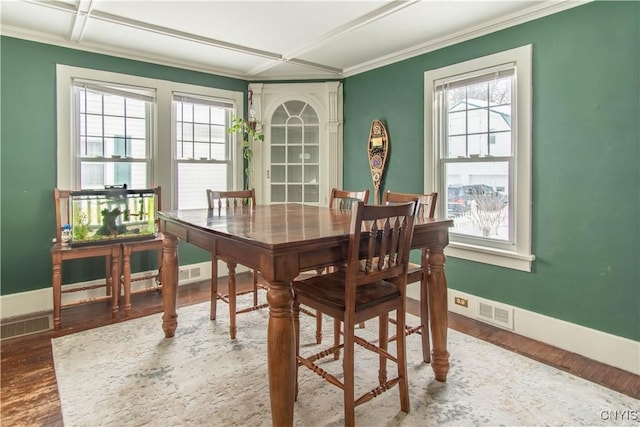 dining area featuring plenty of natural light, visible vents, and wood finished floors