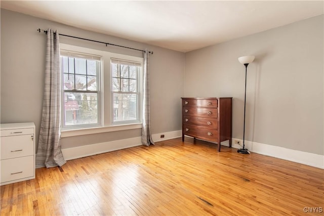 interior space with baseboards and light wood-style floors