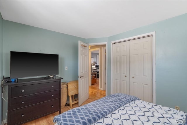 bedroom featuring a closet and light wood finished floors