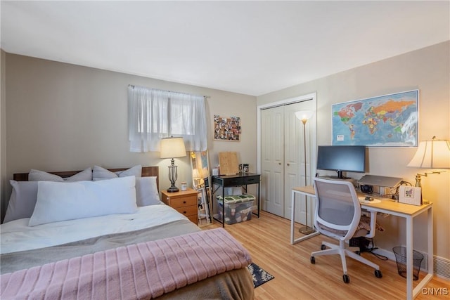 bedroom featuring a closet and light wood-style flooring