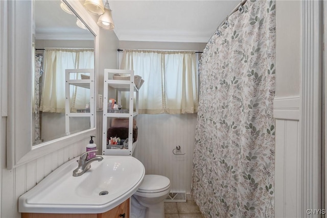 bathroom featuring toilet, tile patterned floors, vanity, a shower with curtain, and crown molding