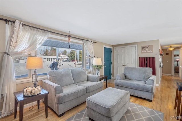 living area featuring baseboards and wood finished floors