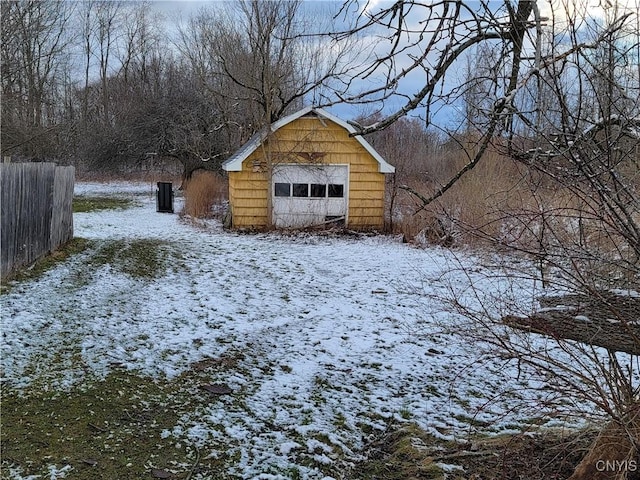 yard layered in snow featuring an outbuilding