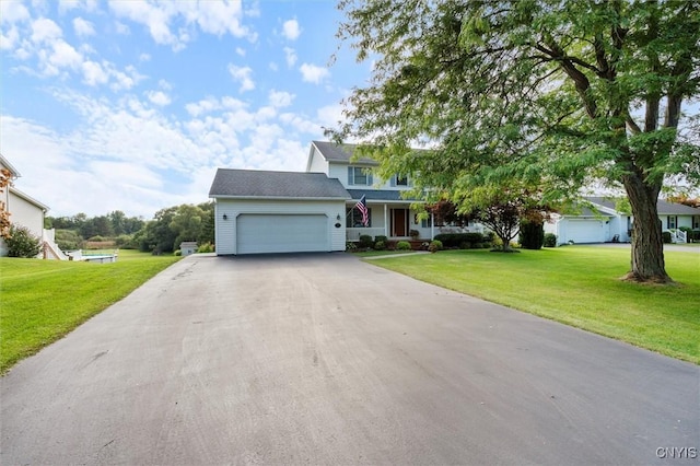 view of front of home featuring driveway, an attached garage, and a front yard