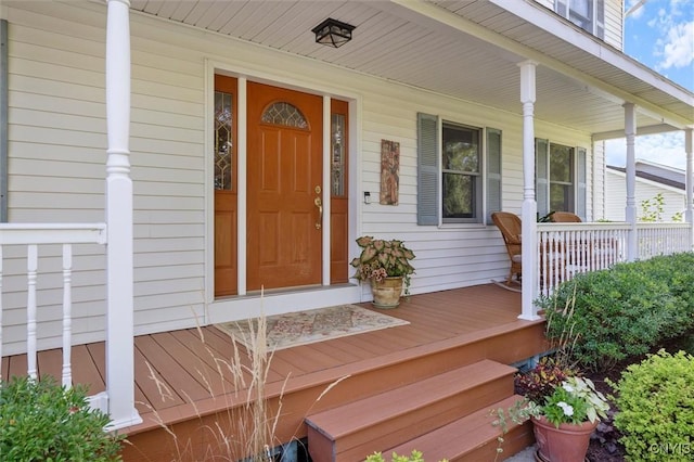 view of exterior entry featuring a porch