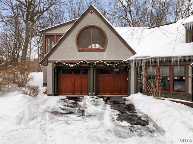 view of front of property with a garage and stucco siding