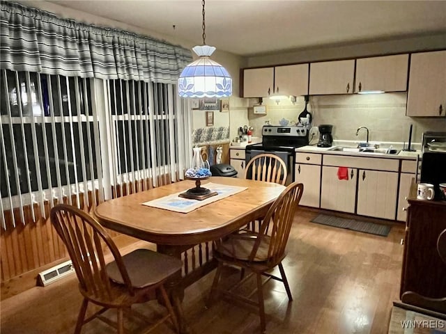 dining space featuring wood finished floors and visible vents