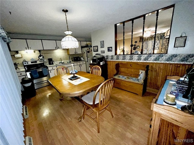 dining space featuring light wood-type flooring