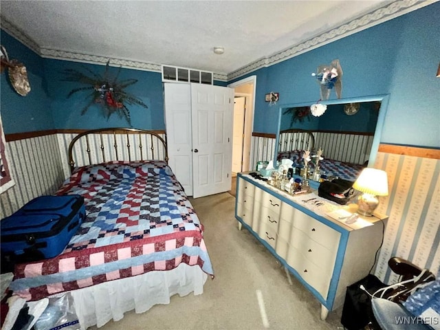 bedroom featuring wainscoting and carpet