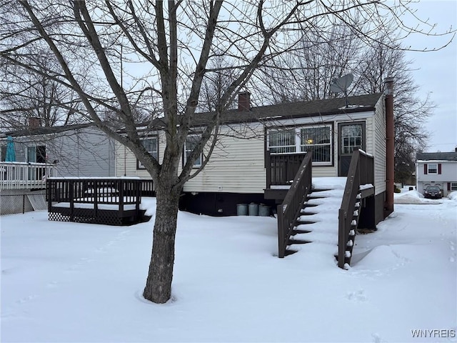 view of front of property with a deck and a chimney