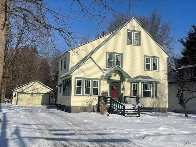 view of front of house featuring a detached garage and an outdoor structure