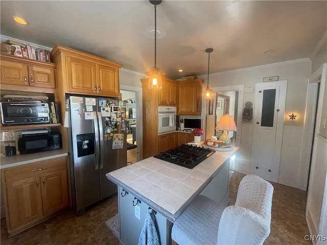 kitchen with tile countertops, a kitchen island, ornamental molding, decorative light fixtures, and black appliances