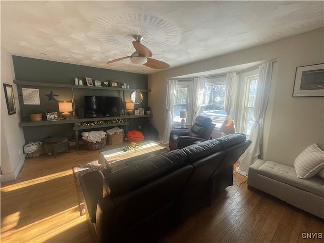 living room featuring ceiling fan and wood finished floors