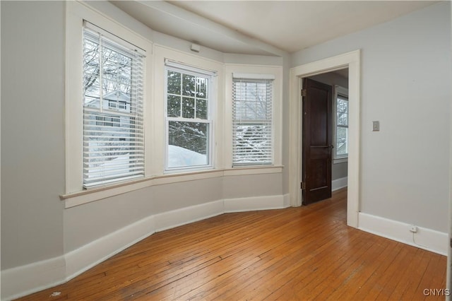 empty room featuring baseboards and wood finished floors