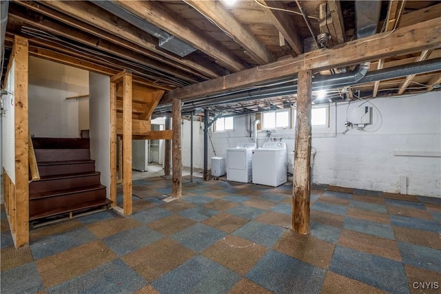 basement with stairway and washing machine and clothes dryer