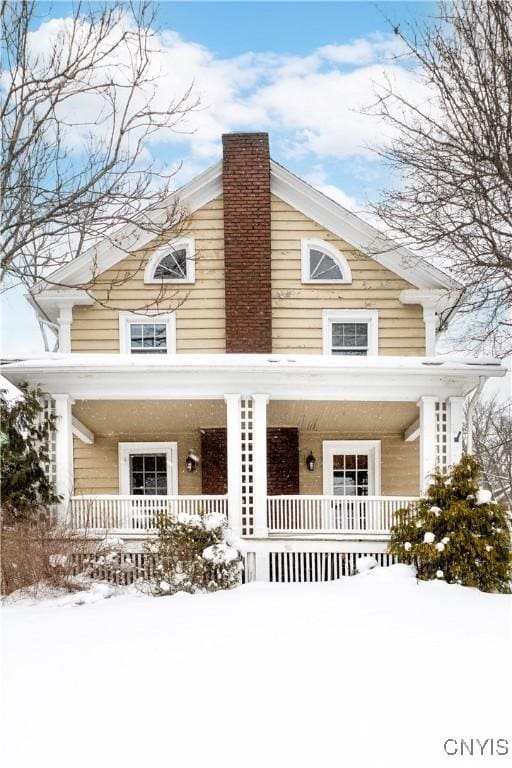 view of front of house with a porch and a chimney