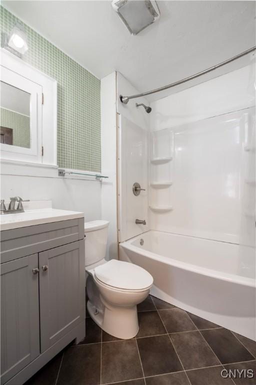 bathroom with toilet, vanity, tile patterned flooring, and shower / tub combination