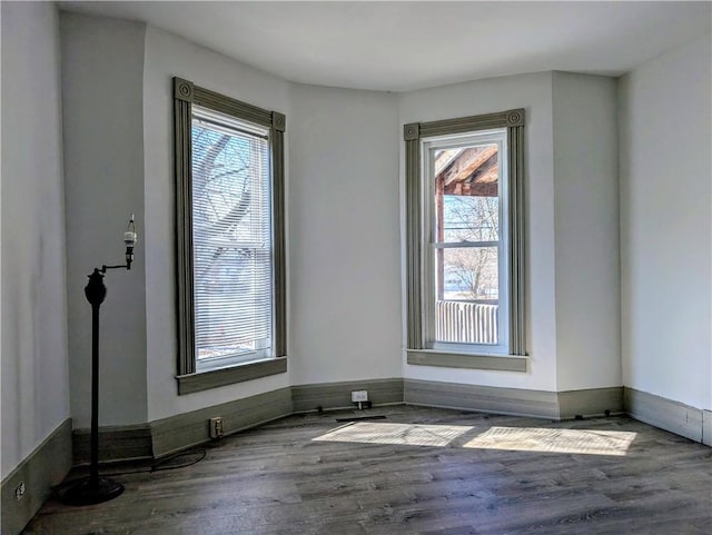 unfurnished room with dark wood-style flooring