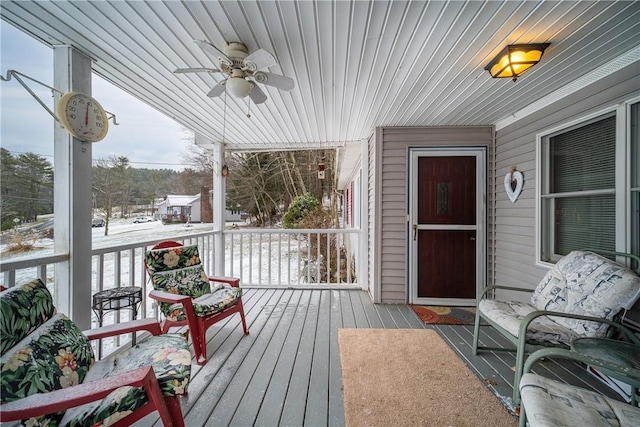 snow covered deck with covered porch and ceiling fan