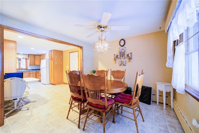 dining space with a baseboard heating unit, baseboards, and a ceiling fan