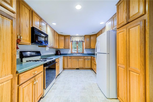 kitchen featuring brown cabinets, dark countertops, recessed lighting, a sink, and white appliances