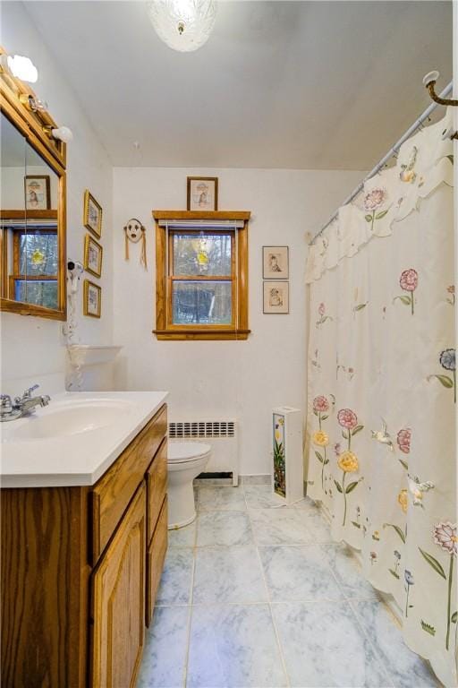 full bathroom featuring radiator, vanity, and toilet