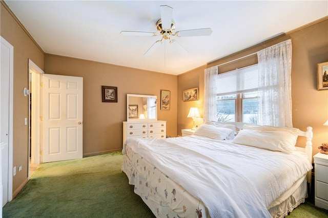 carpeted bedroom featuring baseboards and a ceiling fan