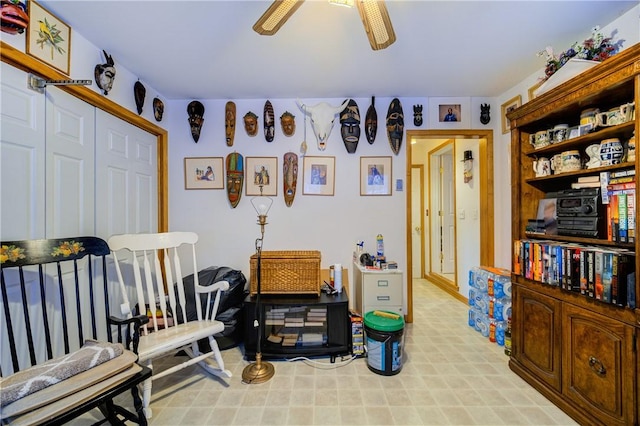 sitting room with a ceiling fan