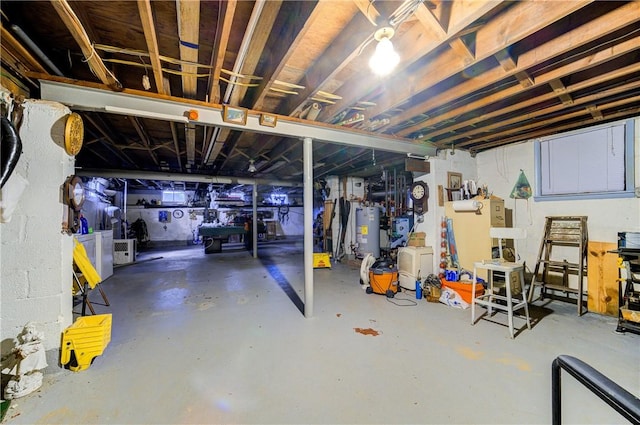 unfinished basement featuring gas water heater