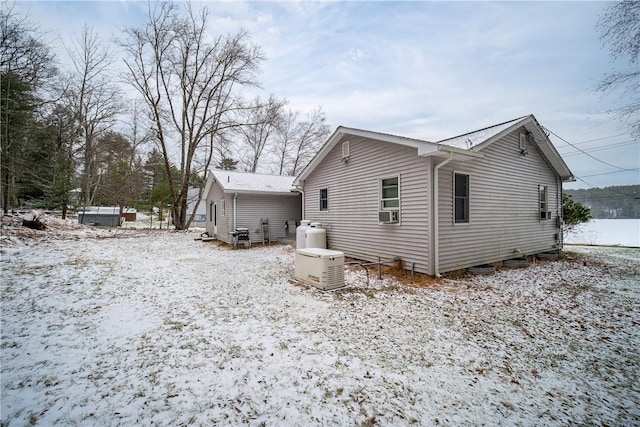 view of snow covered back of property