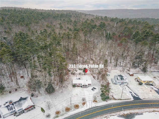 drone / aerial view featuring a forest view