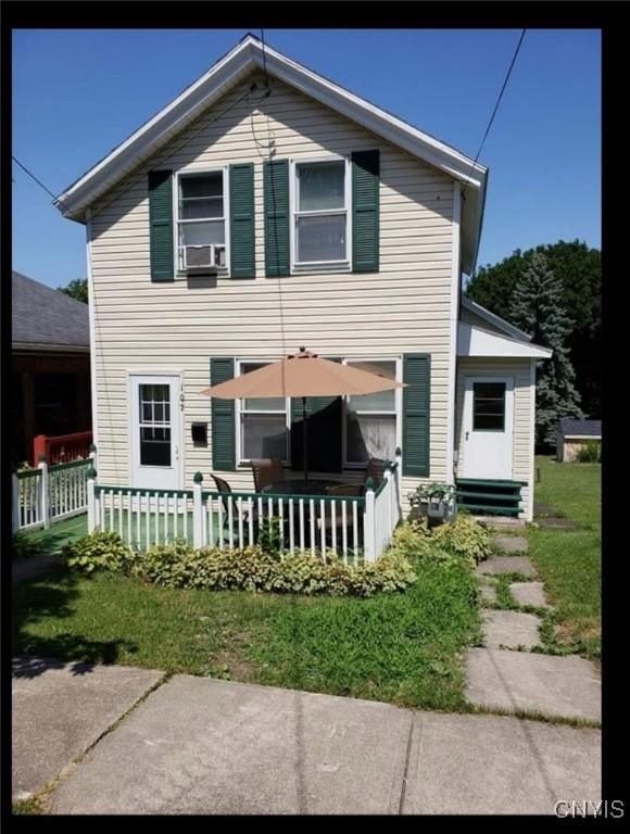 back of property featuring fence and cooling unit