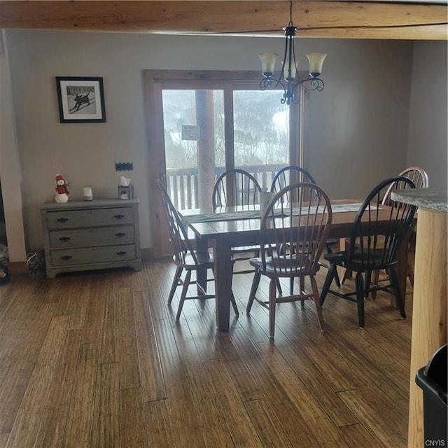 dining space featuring a chandelier and dark wood finished floors