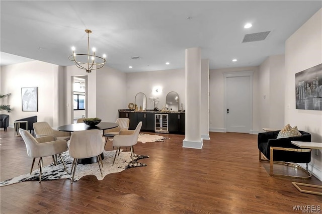 dining area featuring visible vents, dark wood finished floors, wine cooler, a notable chandelier, and recessed lighting