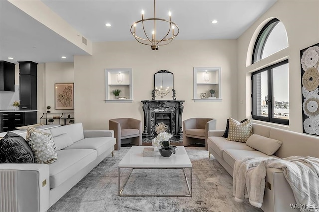 living room with visible vents, a fireplace, a chandelier, and recessed lighting