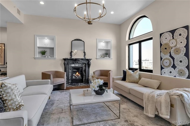 living area with built in features, recessed lighting, visible vents, and a fireplace