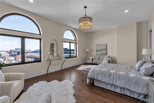 bedroom with baseboards, a chandelier, dark wood-style flooring, and recessed lighting