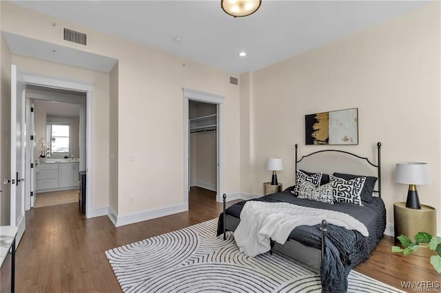 bedroom with dark wood-style floors, baseboards, and visible vents