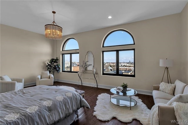 bedroom featuring a chandelier, baseboards, dark wood finished floors, and recessed lighting