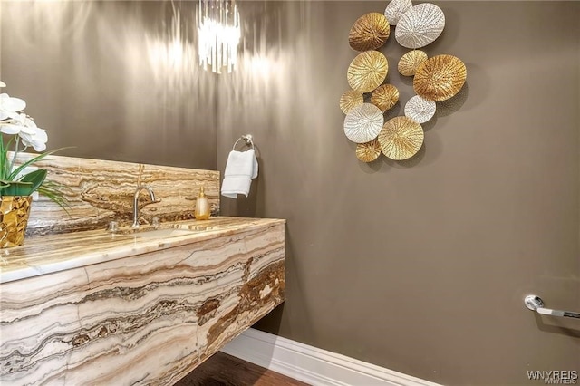 bathroom featuring baseboards and a sink