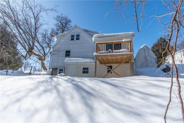 view of snow covered back of property