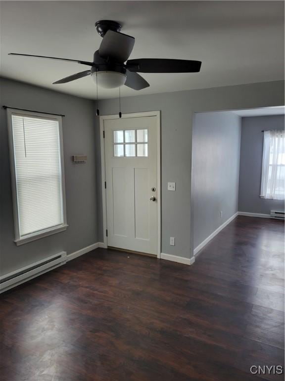 entryway with dark wood-style floors, ceiling fan, baseboards, and baseboard heating