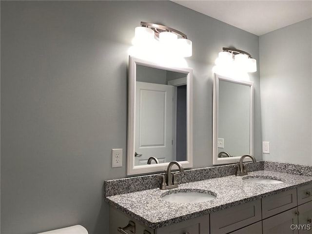 bathroom featuring a sink and double vanity