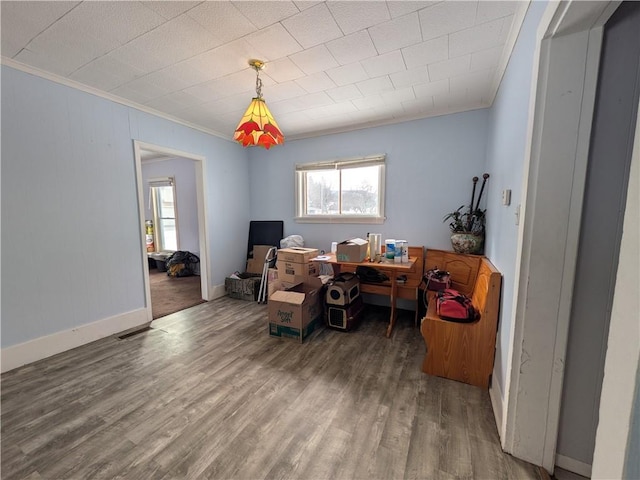 home office featuring baseboards, ornamental molding, and wood finished floors