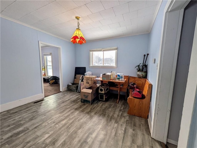 office featuring baseboards, wood finished floors, and crown molding