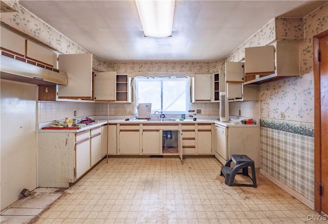 kitchen featuring light countertops, open shelves, light floors, and wallpapered walls